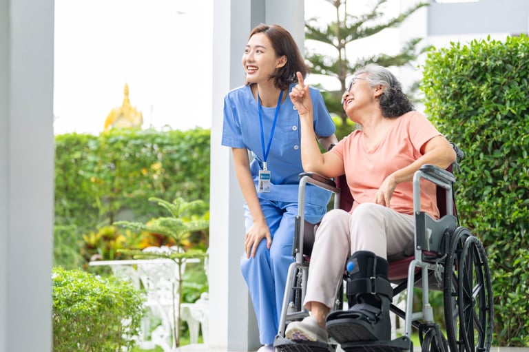 Senior woman laughing with caregiver