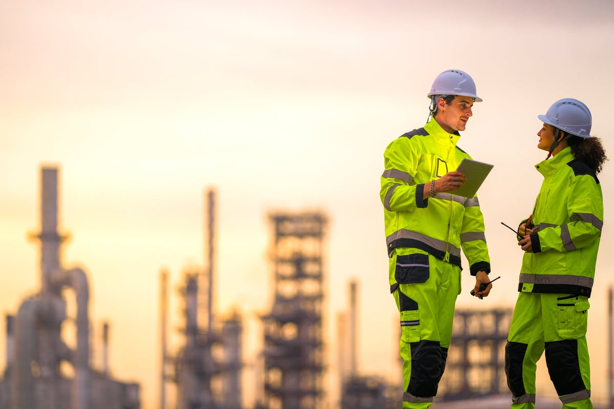 Engineers in hi-vis inspecting a unit during installation
