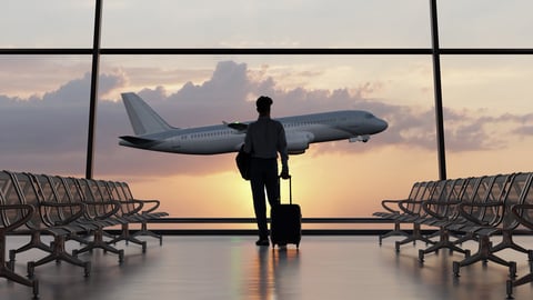 Silhouette of a man walking in the airport at sunset