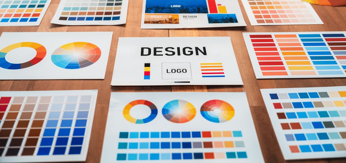 Colour palette swatches arranged on a designer's desk for brand identity development
