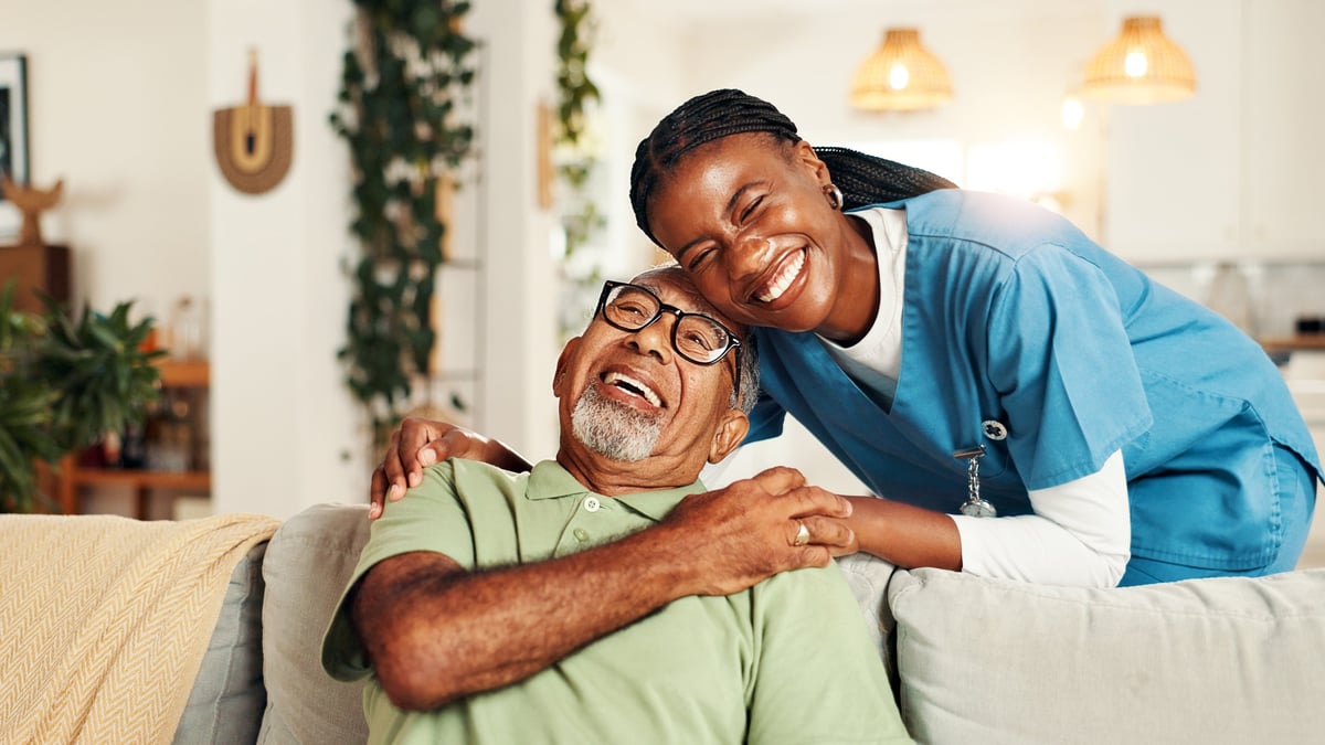 Nurse providing compassionate comfort and care to a senior patient in a hospice setting