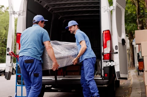 Professional movers loading furniture from client's house
