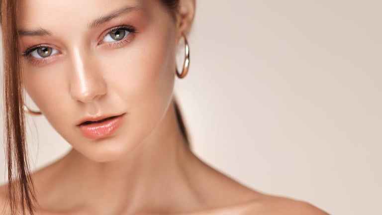 High quality beauty close-up of a young Caucasian woman with natural glowing makeup