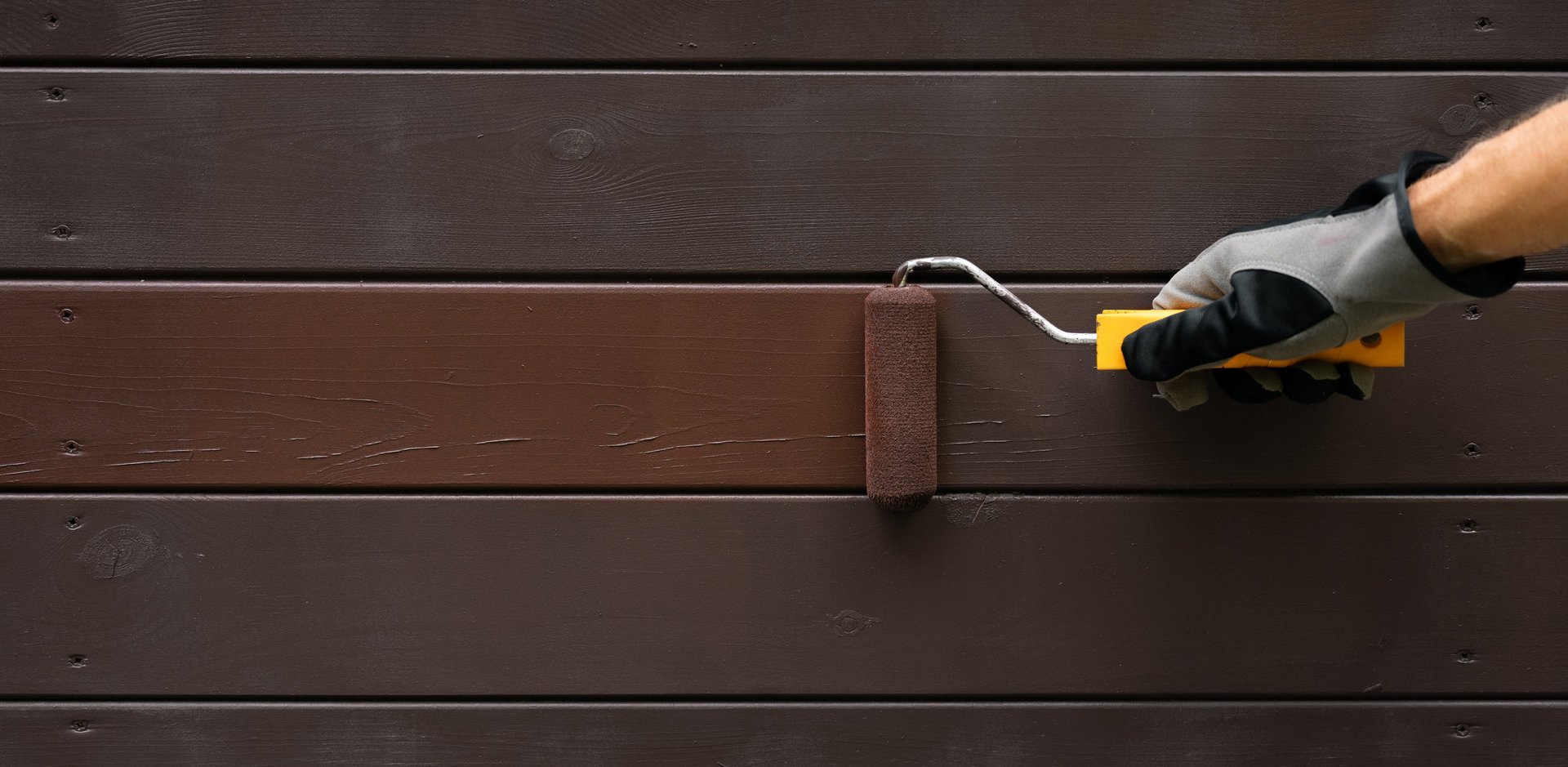 Hand painting wooden house exterior siding