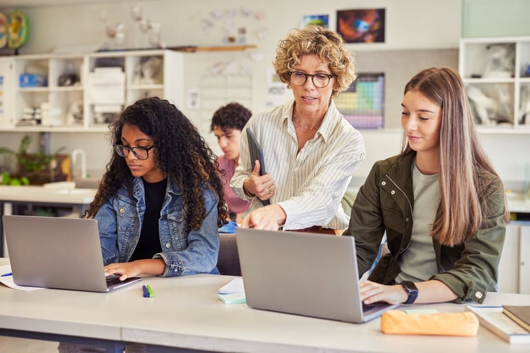 Teacher guiding student through typing instruction with patience and care
