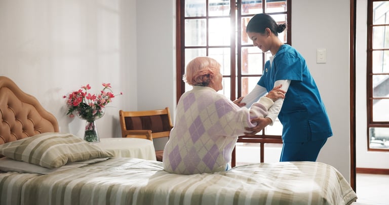 Caregiver assisting senior patient in nursing home