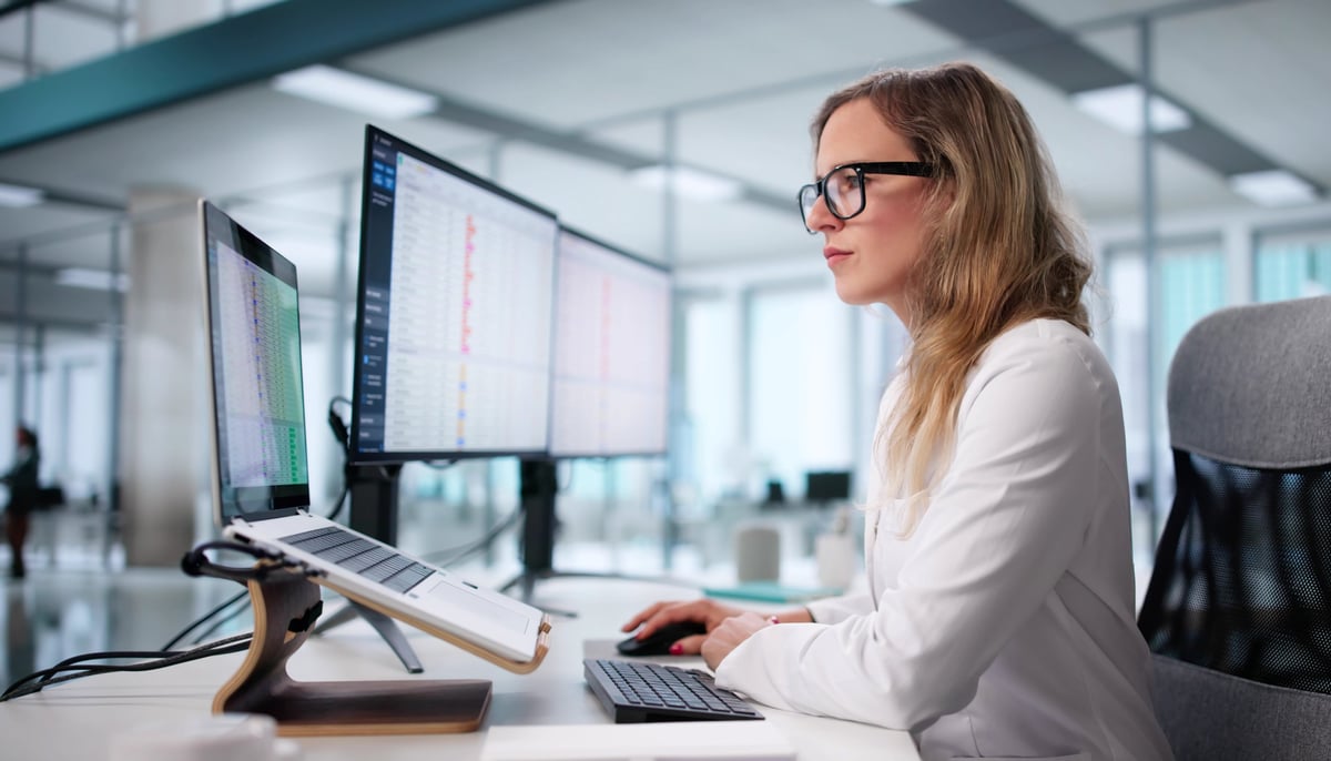Female Doctor Managing Medical Billing Using Healthcare Data Analyst Technology.