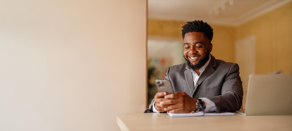 Confident businessman working on laptop
