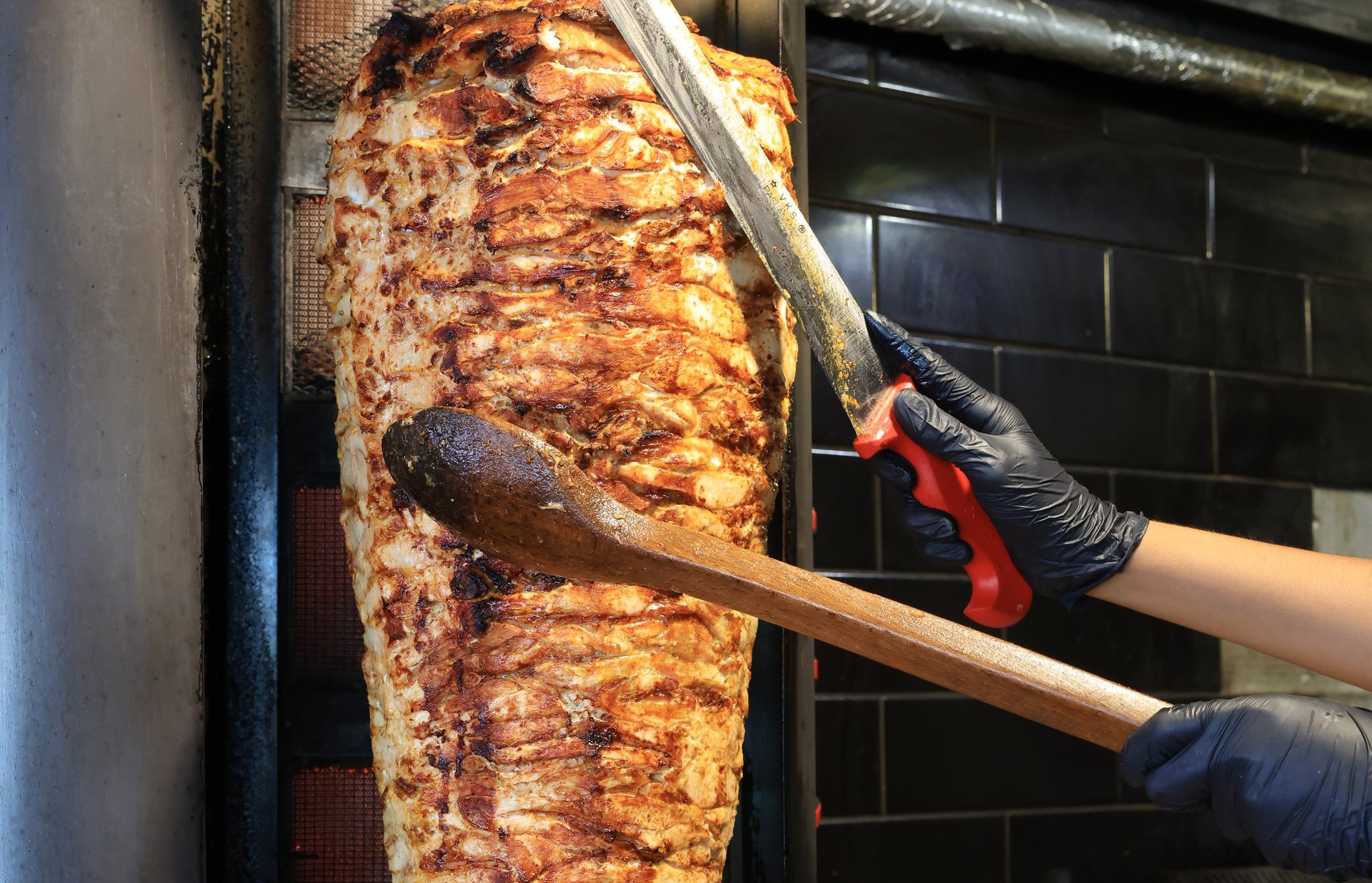 Turkish chicken döner kebap cooking on vertical rotisserie