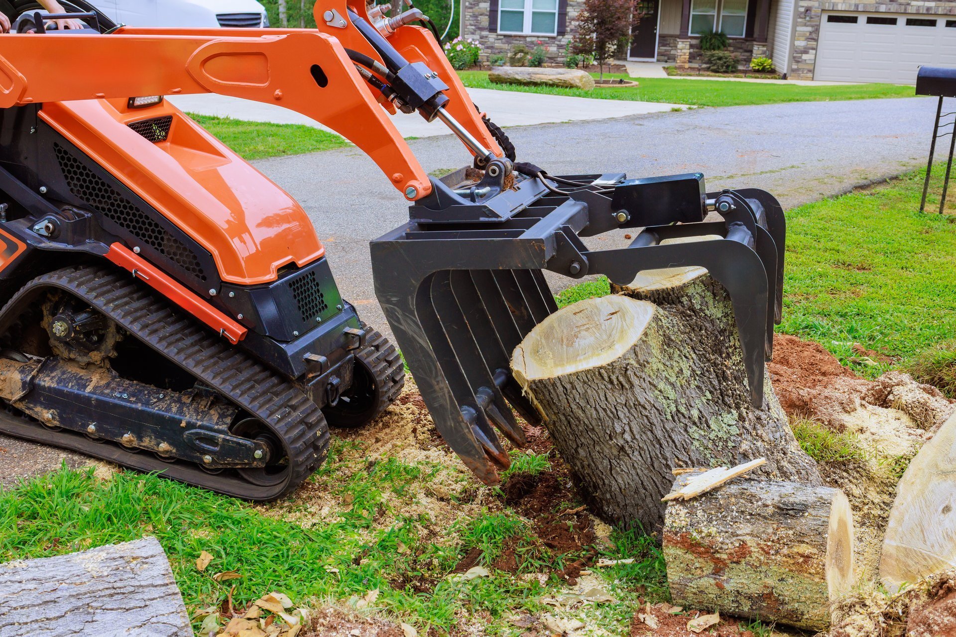 Storm cleanup — skid steer removing debris after tornado