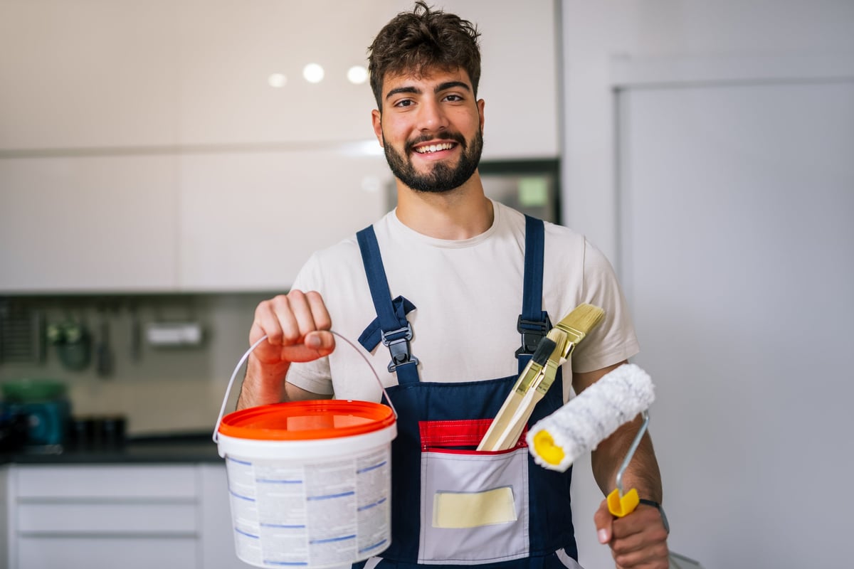 Painter preparing walls with brushes for a precise renovation