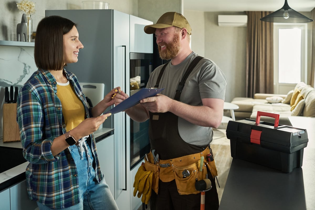 HVAC technician speaking with a homeowner about service findings