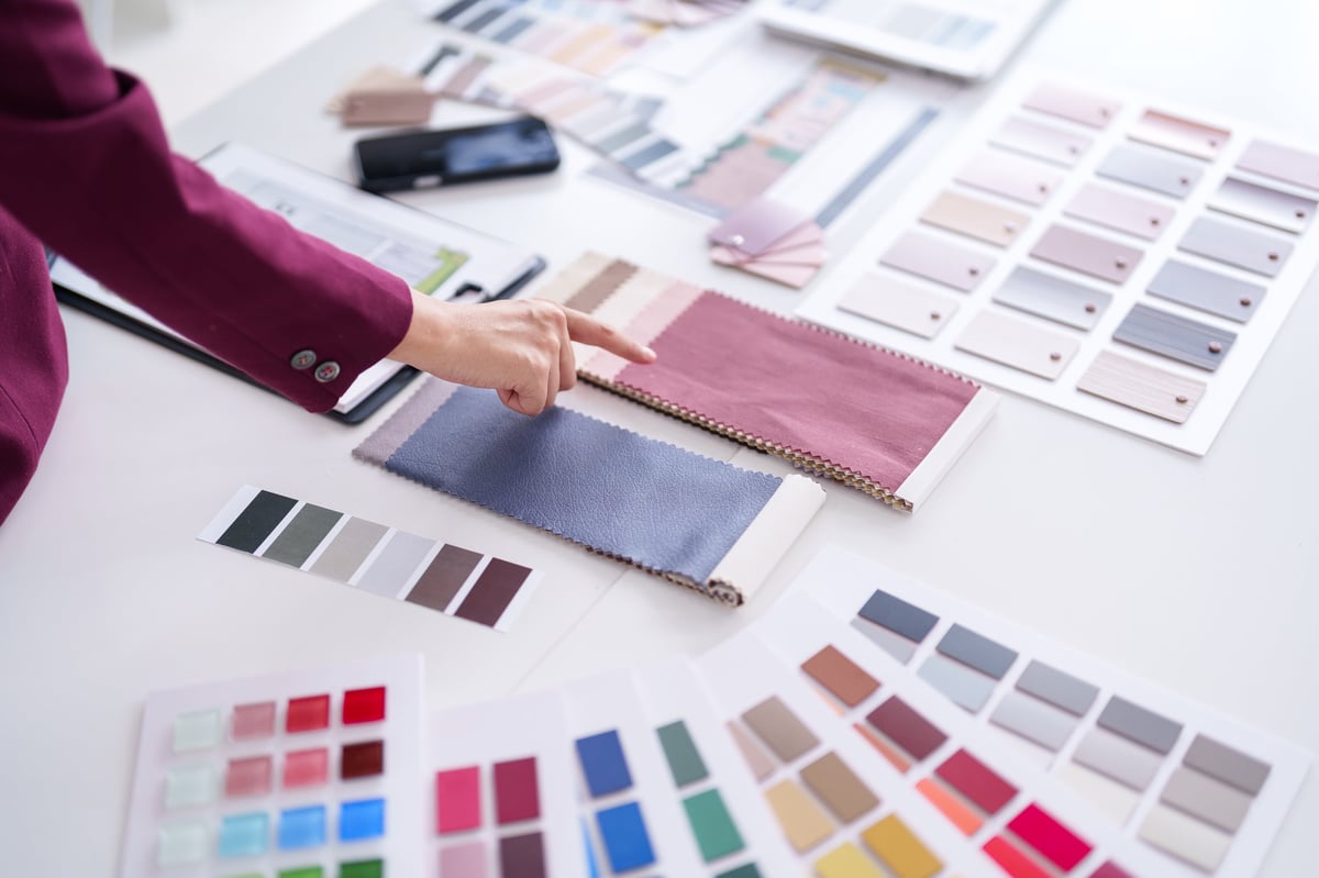 Designer selecting colour and material samples to plan a cohesive brand palette
