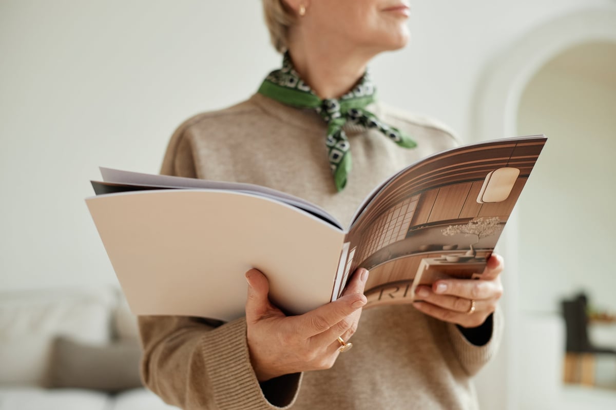 Woman reading interior design magazine