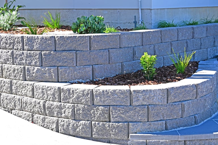 Beautiful curved concrete block retaining wall with garden