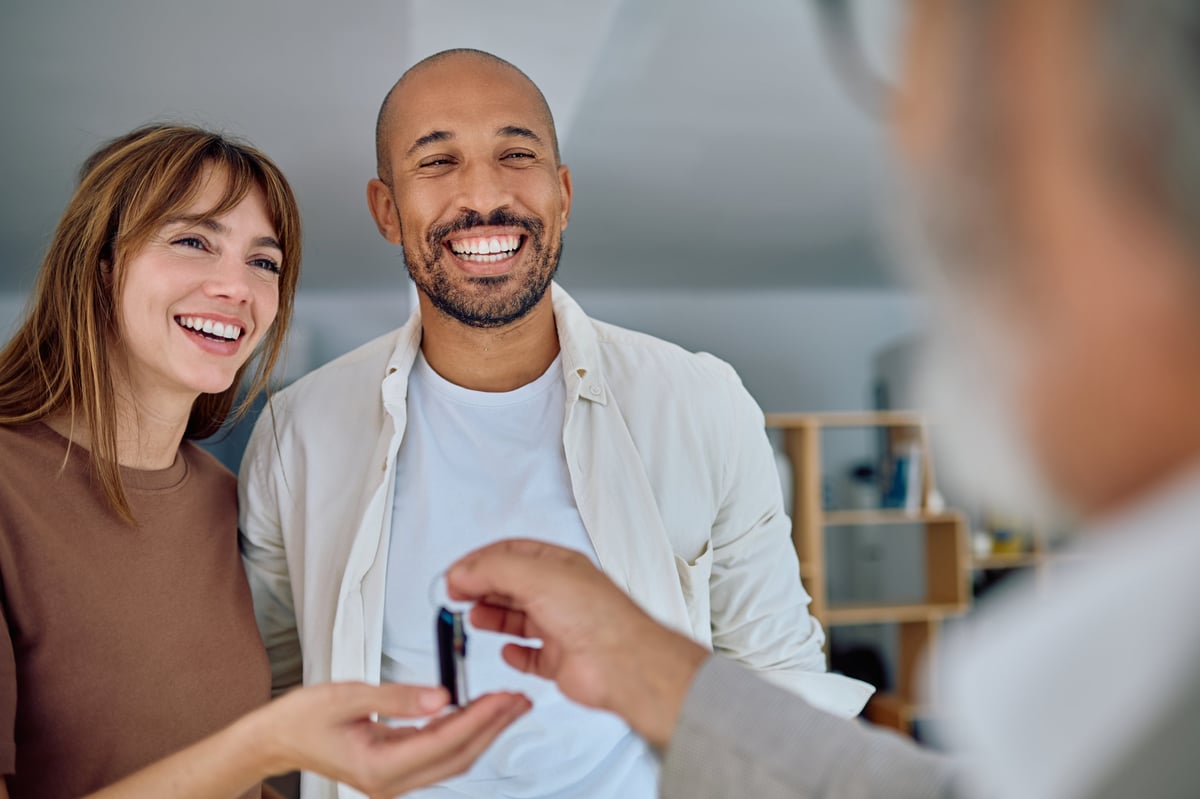 Joyful homeowners celebrating after closing on their first home