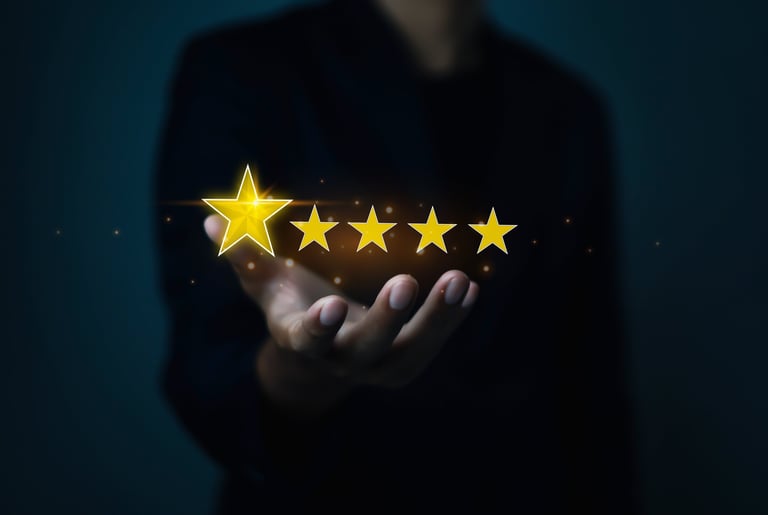 Hand holding five golden stars representing customer review rating and business reputation
