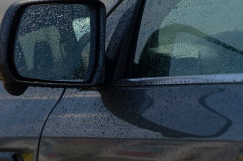 Car with window tint in rain