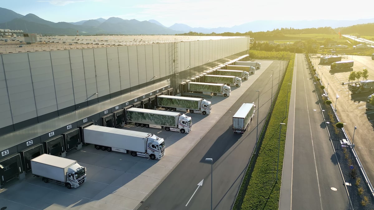 Aerial view of a distribution warehouse with trucks at loading docks