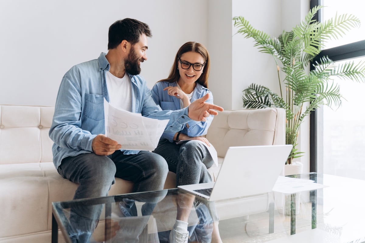 Couple calculating mortgage payments and loan options at home