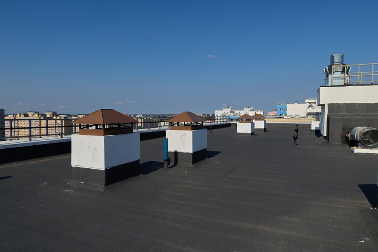 Chimney and roofing detail against blue sky