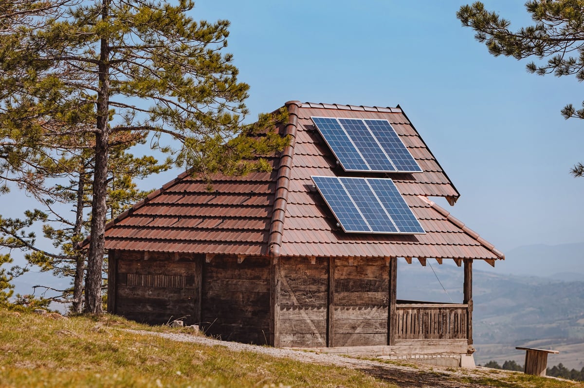Solar panels powering a remote rural house in a scenic landscape
