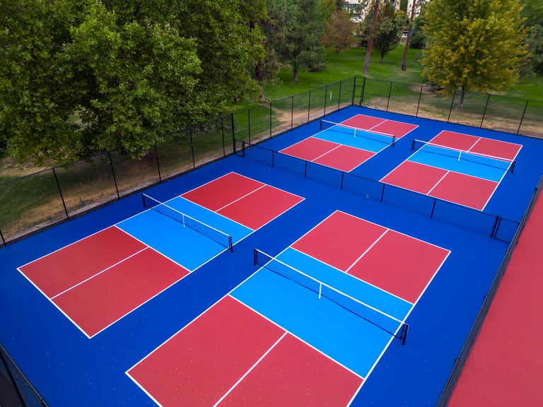 Aerial view of colorful pickleball courts from above showing professional sports surface layout