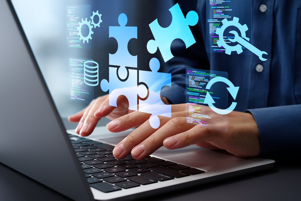 Business owner using a laptop to configure automated business systems