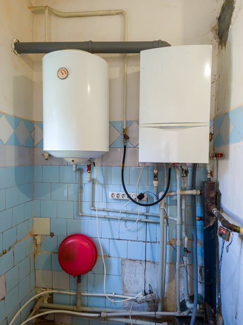 Modern tankless water heater unit mounted on wall — energy efficient on-demand system