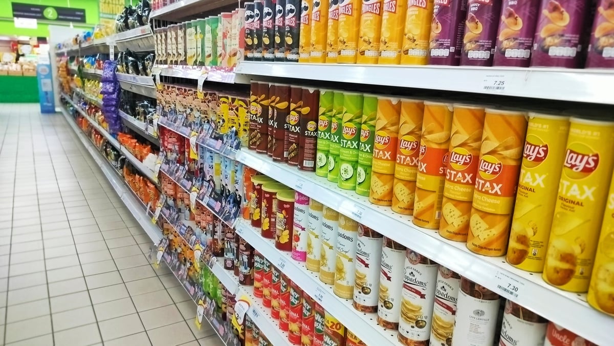 A retail shelf with brightly coloured branded product displays designed to attract attention