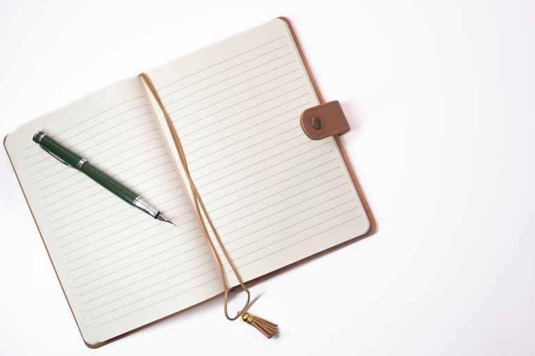 Open notebook with pen, ready for journaling and reflection