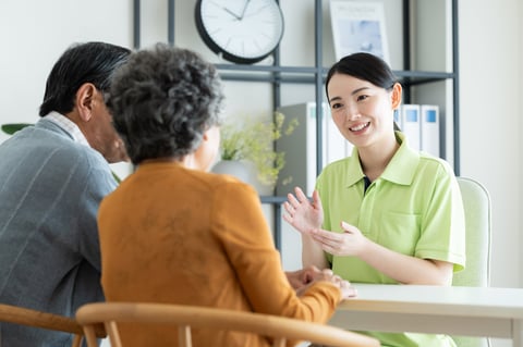 Senior couple consulting with healthcare coordinator about nursing care options