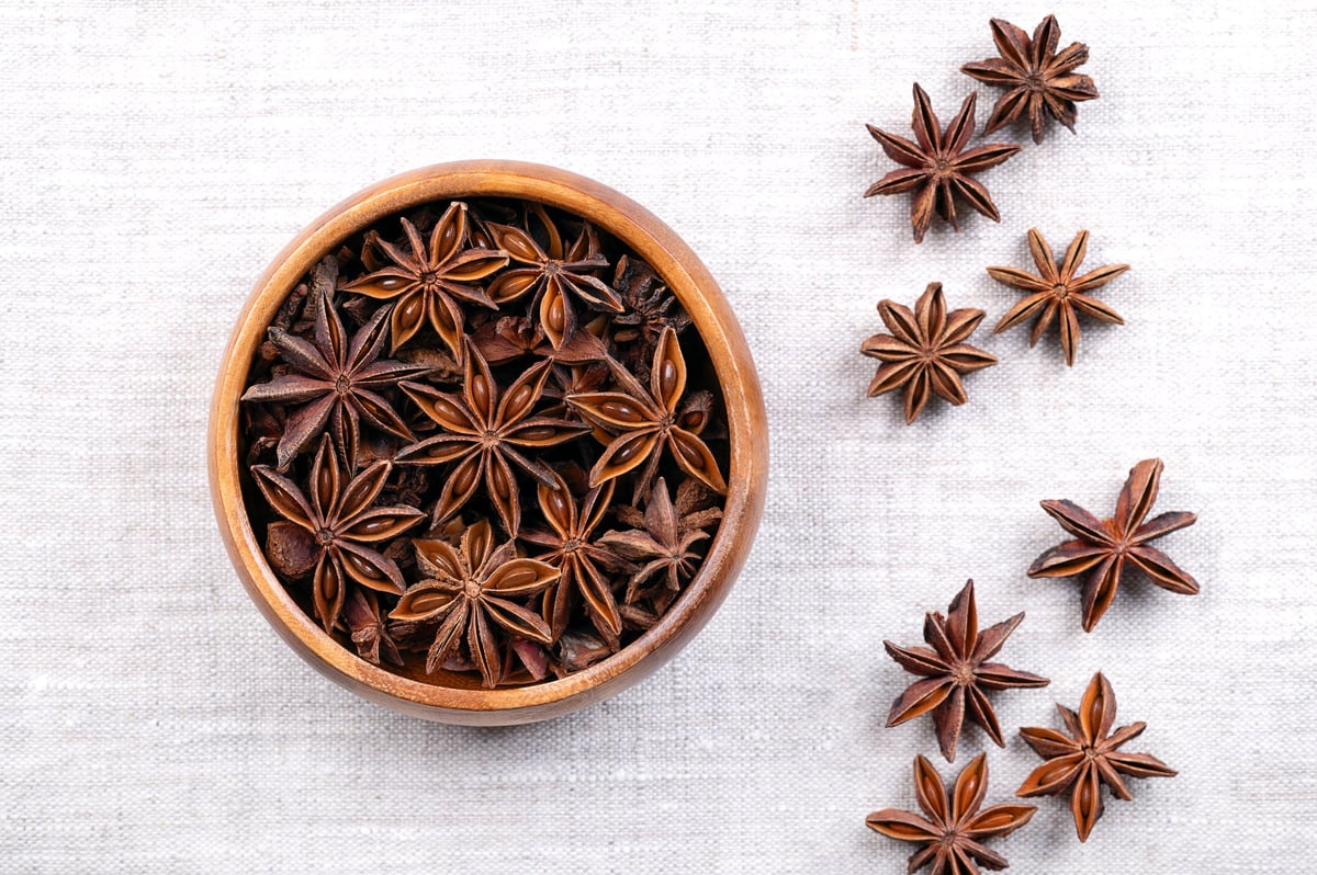 Star anise in wooden bowl — botanical ingredients