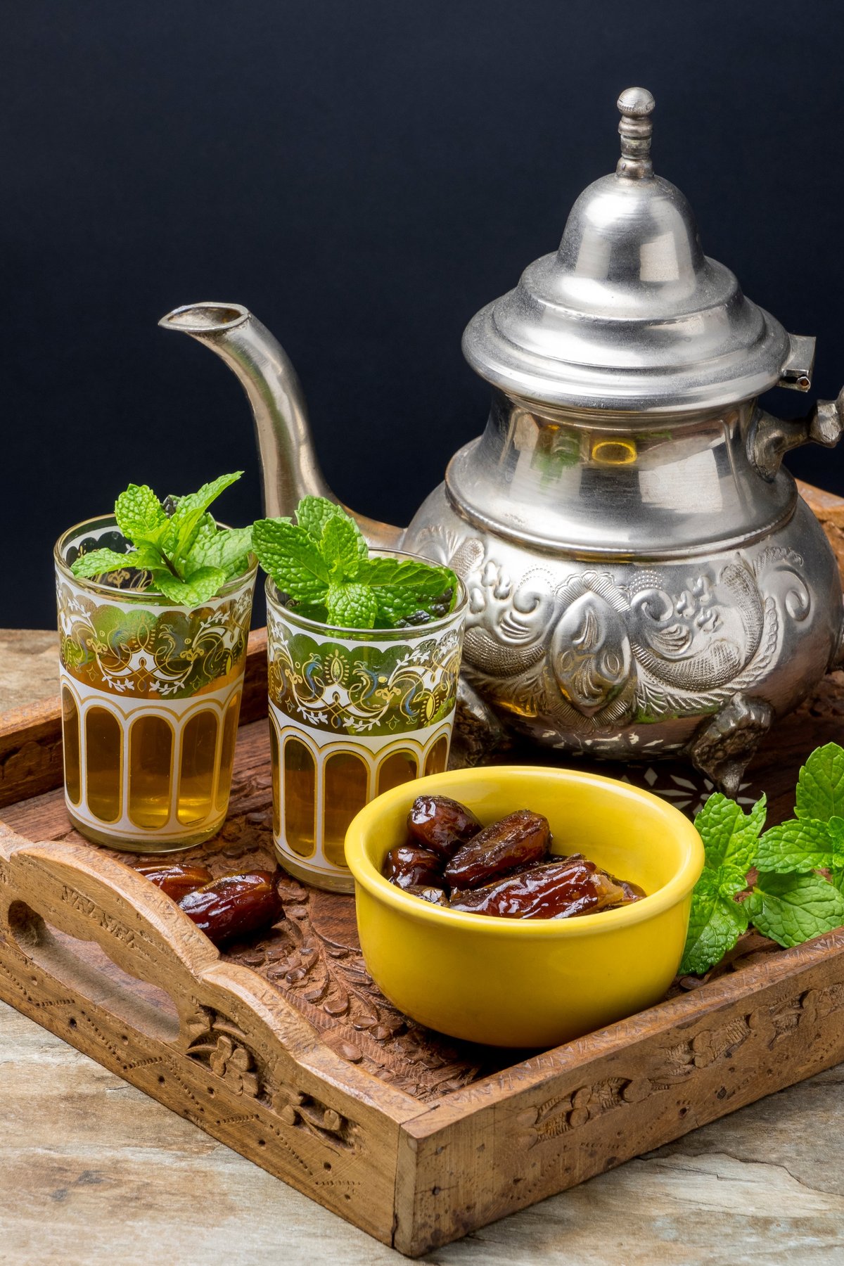 Traditional mint tea served in glasses with dates and fresh mint