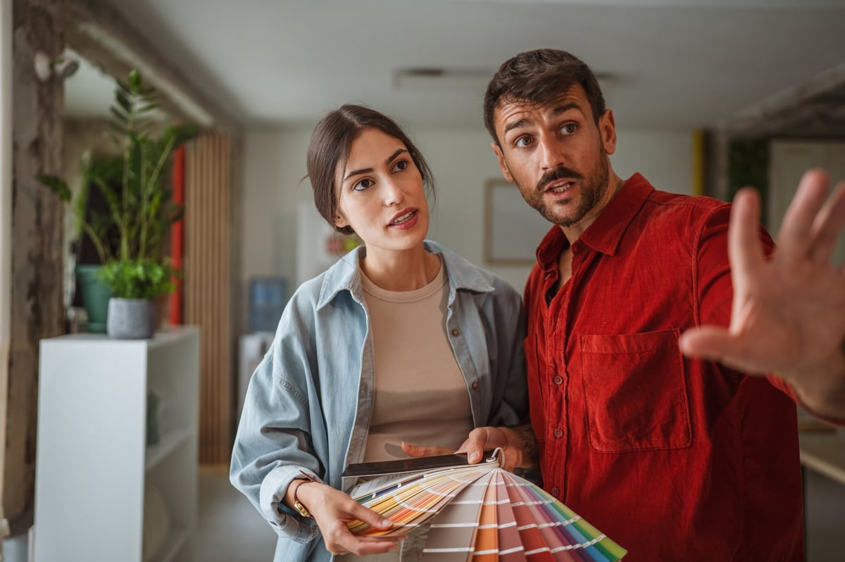 Two designers comparing colour palettes and discussing a project