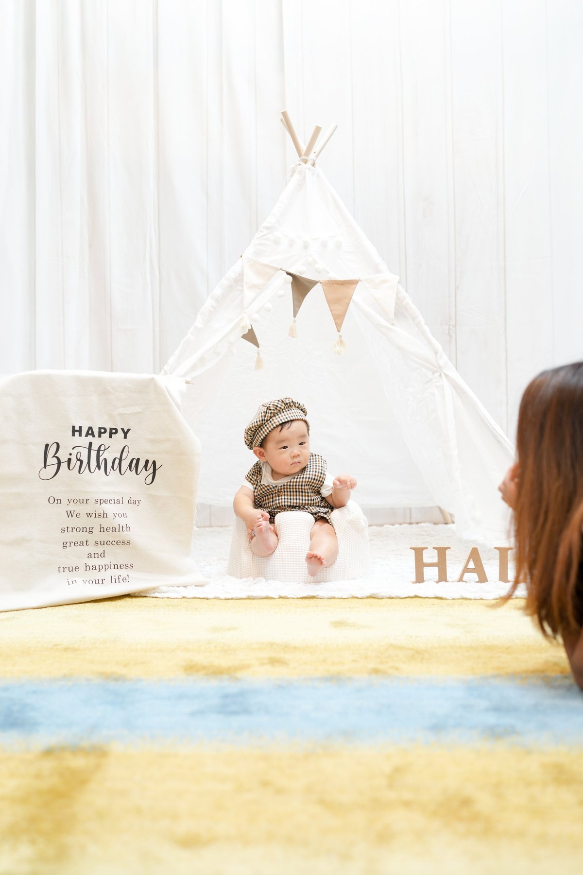 Cozy teepee setup with Happy Birthday styling, soft bedding, and playful decor