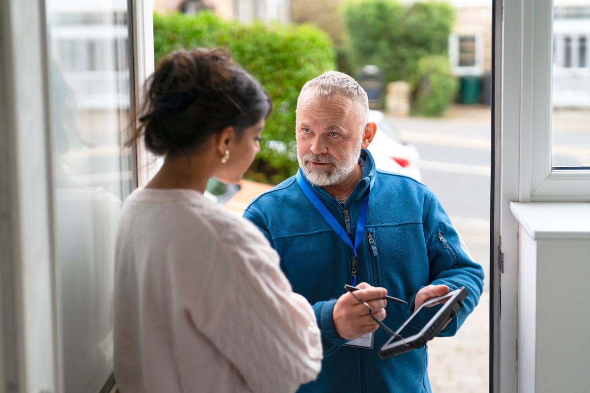 HVAC technician consulting with homeowner, discussing service findings professionally