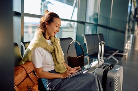 Traveler in airport waiting area, preparing for flight