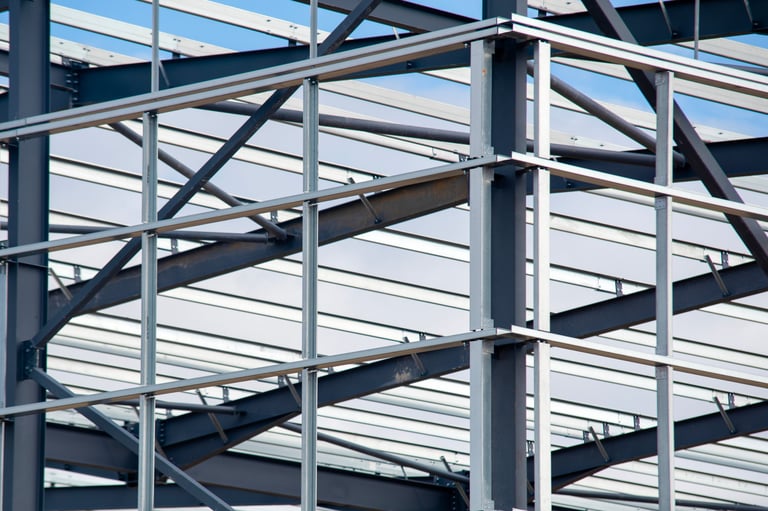 Workers constructing new building steel structure under blue sky