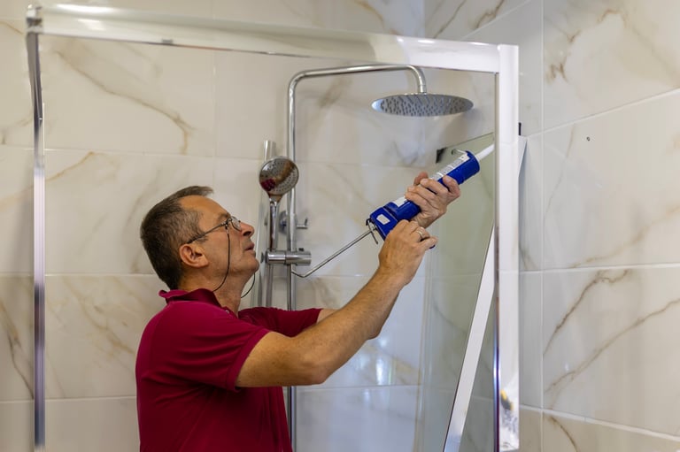Contractor applying sealant during home renovation