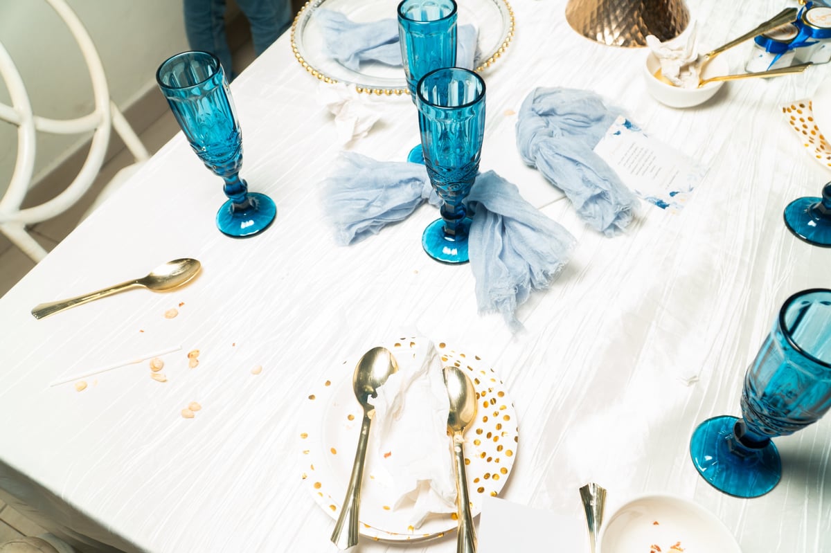 Dirty dishes on tablecloth after event