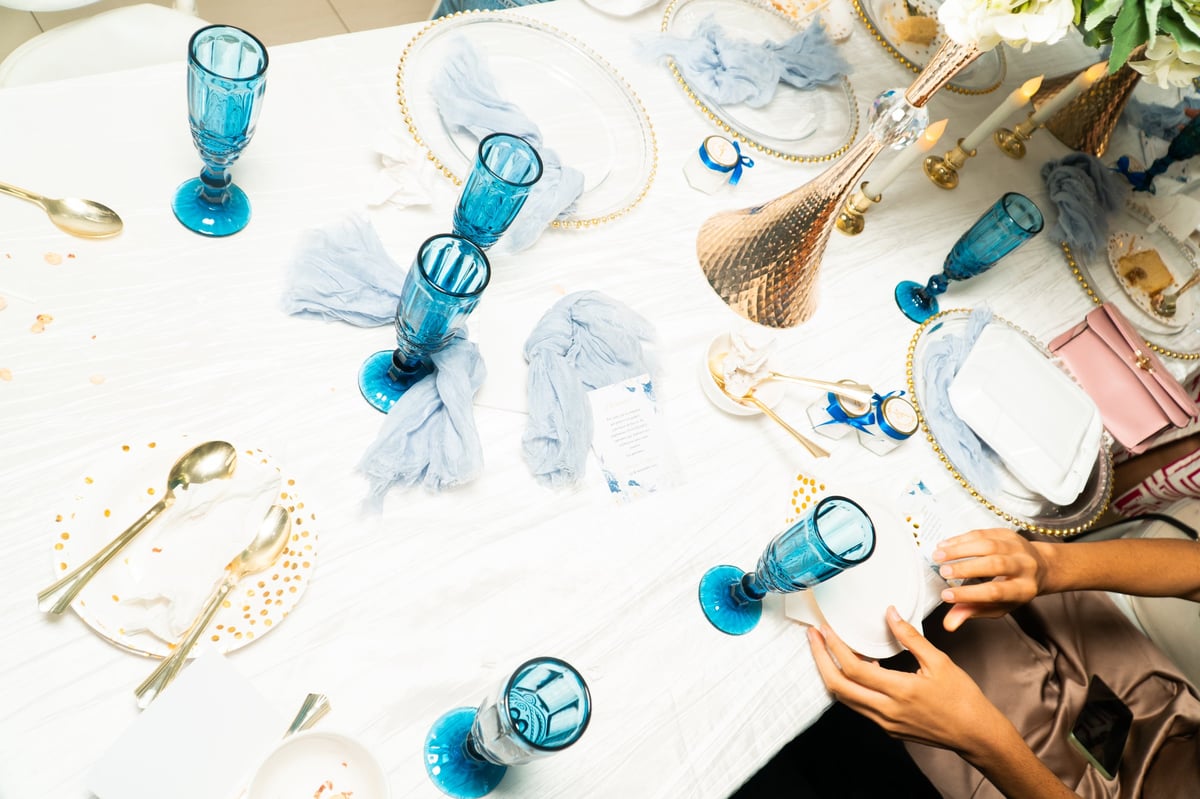 Messy wedding reception table with decorations to be removed
