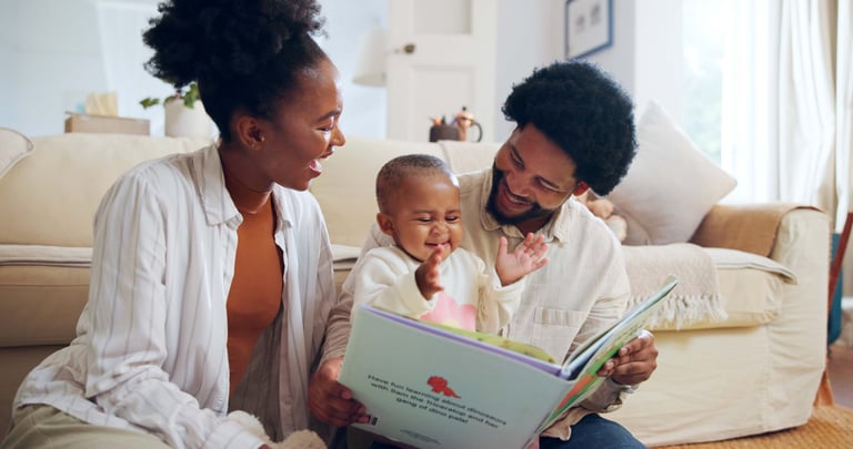 Happy family reading together with their child at home