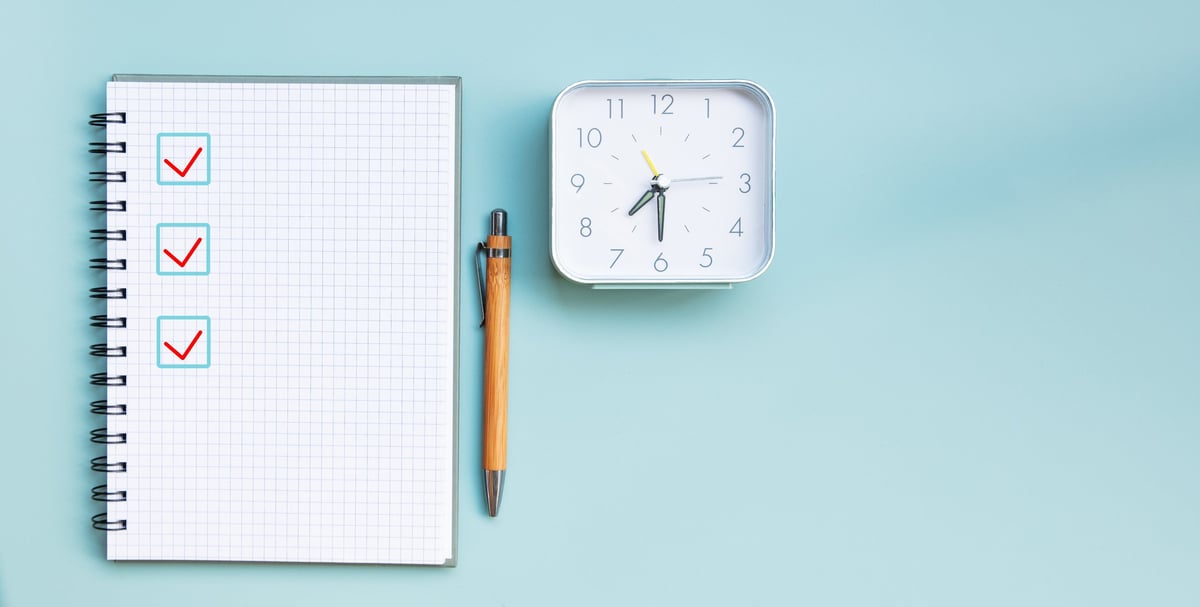 Checkliste mit Notizbuch, Stift und abgehakten Kästchen – Symbolbild für die Ummeldung-Checkliste nach dem Umzug