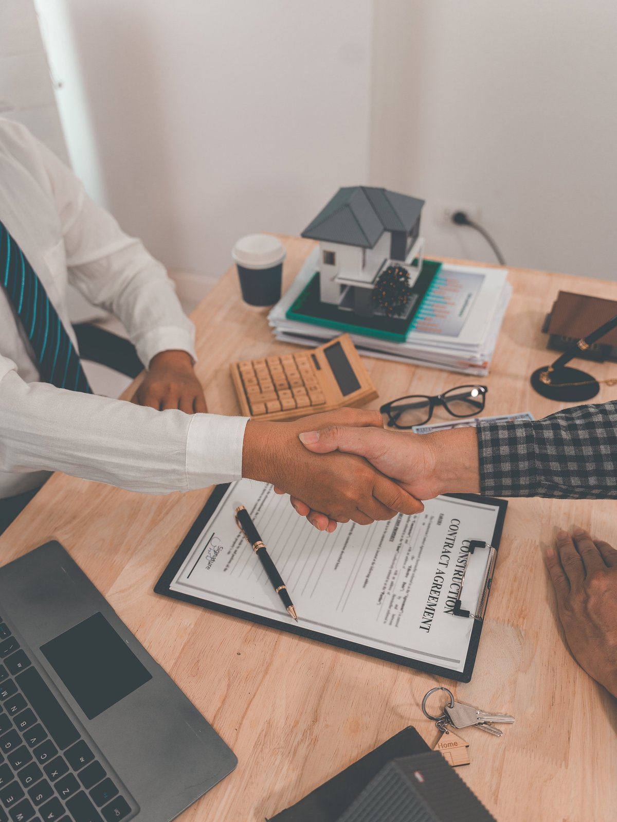 An agency partner and housing professional shaking hands to finalize a housing partnership