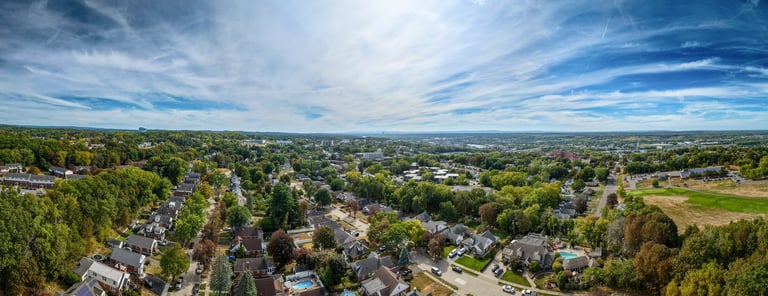 Spacious suburban Knoxville area filled with houses and green trees under bright sun