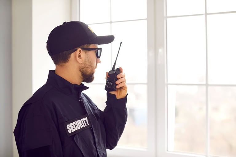 Security guard on a radio checking a property