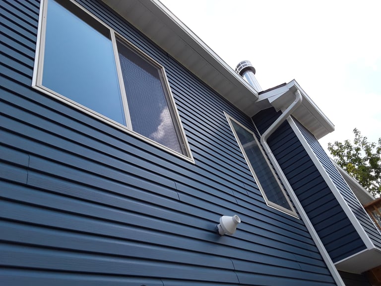Home improvements with blue vinyl siding