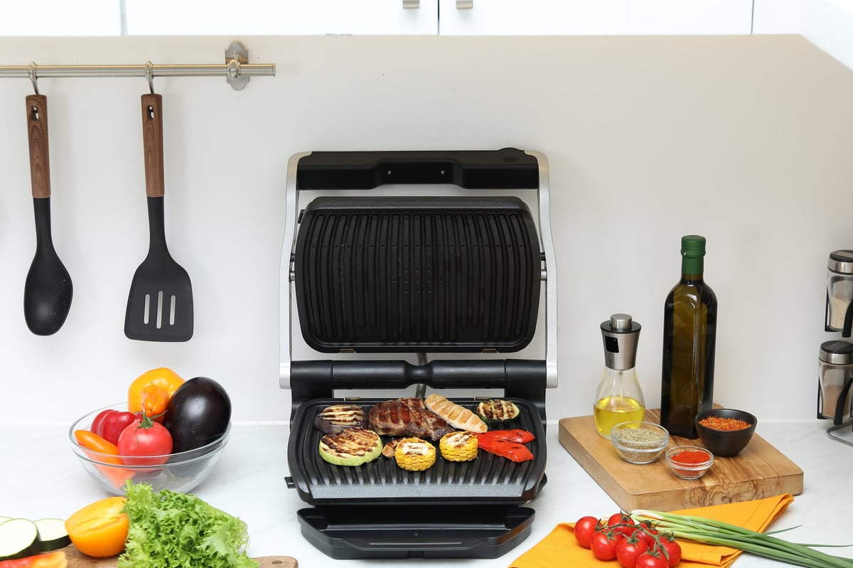 VORA electric grill on a bright kitchen counter with fresh ingredients ready to cook