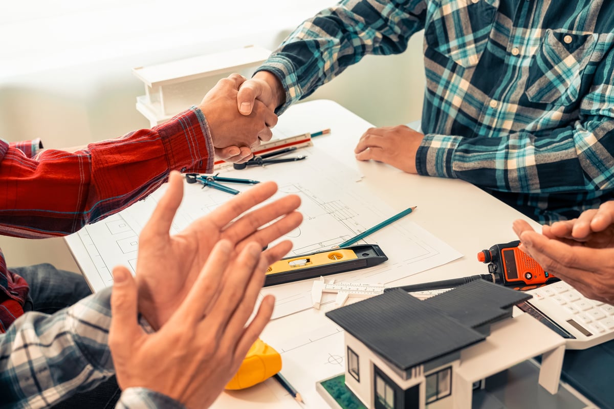 Homeowners reviewing renovation plans and financing options together